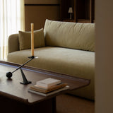 Conrad Lounge Table in dark stained oak veneer with books and an Interconnect Candle Holder in a warm interior.