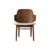 The Penguin Wooden Lounge Chair in red-stained oak with a textured light beige seat, viewed from the front.