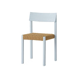 Mauro Dining Chair in linen blue stained oak with a natural handwoven paper cord seat, shown at an angle.