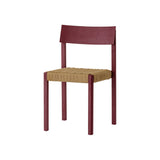 French red Mauro Dining Chair featuring a handwoven paper cord seat and solid wood frame, shown from an angled profile.
