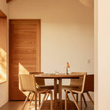 Puffin Dining Table in oak with Ready Dining Chairs and an Admiral Portable Table Lamp in a warm minimalist setting.