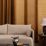 A beige Offset Sofa styled with a Plinth coffee table, Etruscan Pitcher, Androgyne Side Table, and a Torso Table Lamp.