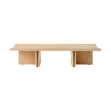 Conrad Lounge Table in natural oak veneer, shown from the front against a black background.