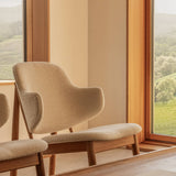 Penguin Wooden Lounge Chair in Logan Fossil upholstery and oak, positioned by a window and Conrad Lounge Table.