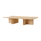 Conrad Lounge Table in natural oak veneer, shown from an angle highlighting its upward-curving edges and solid wood base.
