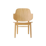 The Penguin Wooden Lounge Chair in natural oak, featuring a curved veneer back and solid oak frame.