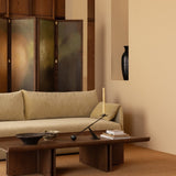 Conrad Lounge Table in dark stained oak veneer paired with a sofa and decorative items in a styled interior setting.