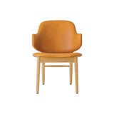 The Penguin Wooden Lounge Chair featuring cognac leather upholstery and a natural oak frame, seen from the front.